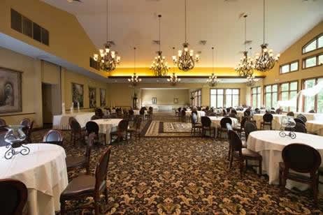 Holidays & Catering 26 Terraview dining hall with multiple chandeliers and tables set in black cloths
