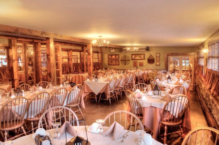 Holidays & Catering 5 The Stroudsmoor Inn Stone room is a large dining area with numerous tables covered in rose table clothes