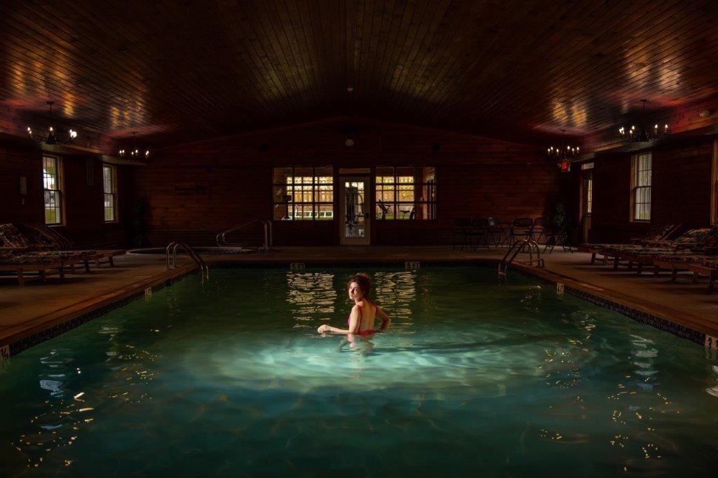 Inn Packages 1 Woman enjoying a swim in the indoor pool