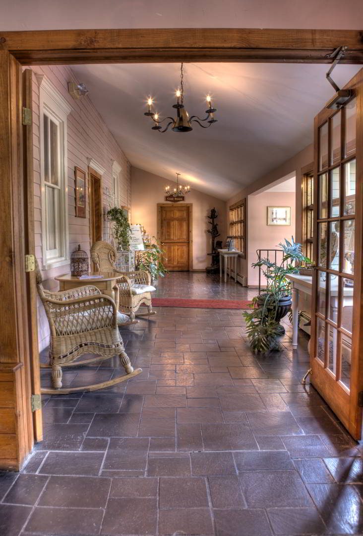 A Boutique Resort in the Pocono Mountains 1 Main Inn breezeway, rocking chairs, tile floors