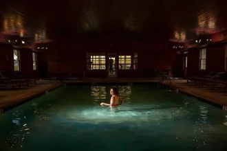 Woman enjoying a swim in the indoor pool at a boutique Poconos resort